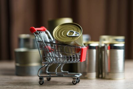 Photo for Canned food in shopping cart toy with group of Aluminium canned - Royalty Free Image