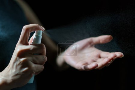 Photo for Woman hand using sanitizer spray, alcohol spraying disinfectant - Royalty Free Image