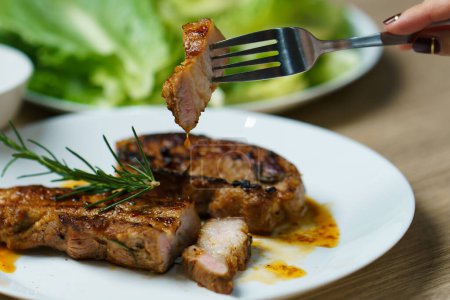 Photo for "Pork juicy steak grill with vegetables and spices." - Royalty Free Image