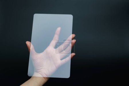 Photo for Hand holding and showing transparent tablet device - Royalty Free Image