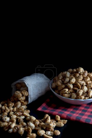 Photo for Crispy Sugared peanuts in Sack and white cup - Royalty Free Image