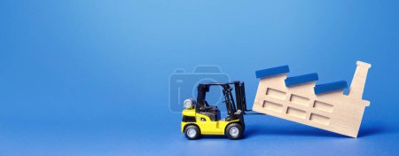 Photo for Forklift truck transports a factory plant to new location. Revision of strategy for allocation of production facilities. Change in manufacturing chains. Rejection of heavy dirty industry - Royalty Free Image
