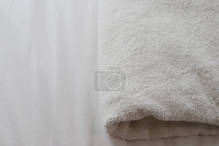 Photo for White folded towels placed on the bed. - Royalty Free Image