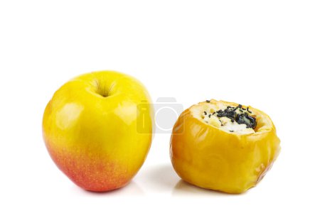 Téléchargez les photos : Pommes fraîches jaunes et farcies au four avec graines de sésame et noix isolées sur un fond blanc - en image libre de droit