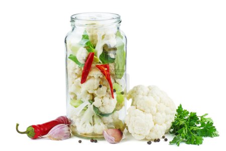 Photo for Cauliflower prepared for canning in glass jar - Royalty Free Image