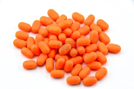 Photo for Pile of orange Tic Tacs on white background - Royalty Free Image