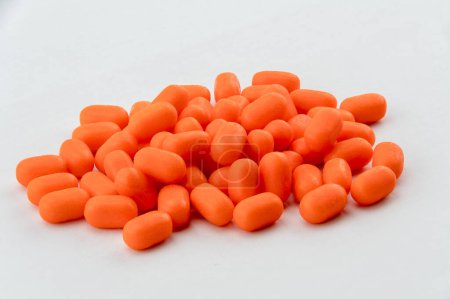 Photo for Small orange tic tac candy sweets on white background - Royalty Free Image