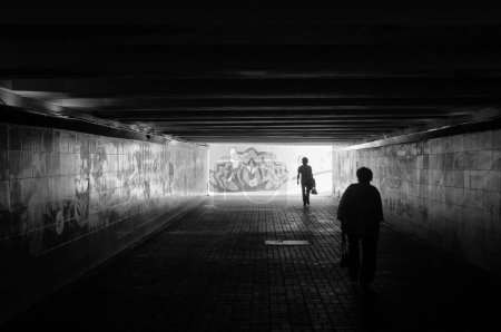 Photo for Silhouette of people in tunnel on the background of the city - Royalty Free Image