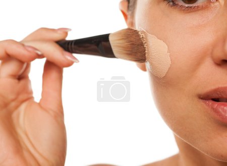 Photo for Woman applied liquid foundation on her face - Royalty Free Image