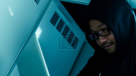 Photo for A computer programmer or hacker prints a code on a laptop keyboad - Royalty Free Image