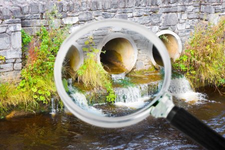 Téléchargez les photos : Eau toxique coulant dans un tuyau d'évacuation en béton vers la rivière - en image libre de droit
