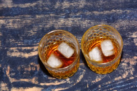 Photo for Whiskey in glass with cubes of ice - Royalty Free Image