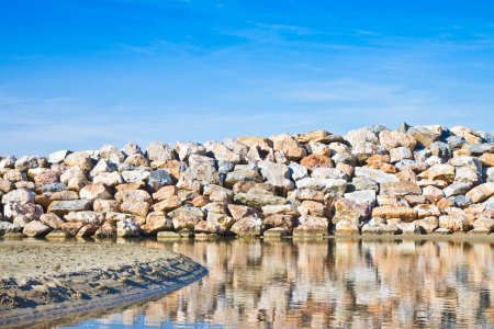 Photo for Retaining breakwater wall built with stone boulders - Royalty Free Image