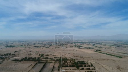 Photo for "Aerial view of small poor village with school in the middle of dry farmland" - Royalty Free Image