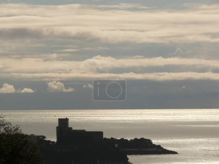 Foto de Silueta del castillo de Lerici al atardecer. Cielo con nubes - Imagen libre de derechos
