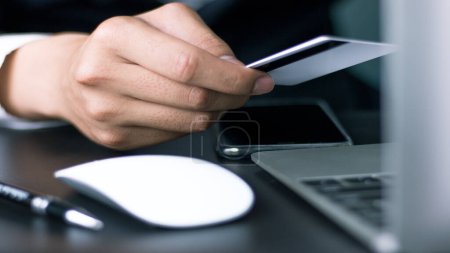 Photo for "Online payment, use credit card instead of cash to buy online, male businessman holding credit card." - Royalty Free Image