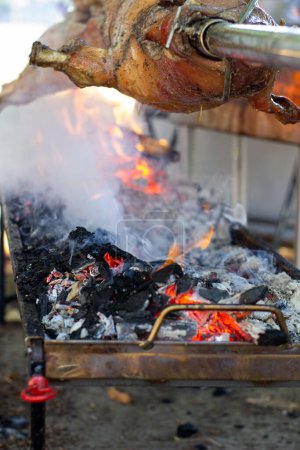 Photo for "Roast pig on a spit. Pig cooking in Germany" - Royalty Free Image