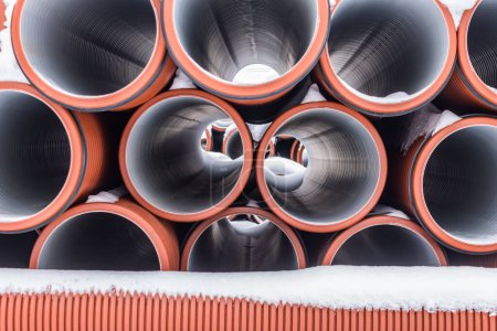 Photo for Large sectional sewer pipes covered with snow during winter construction - Royalty Free Image