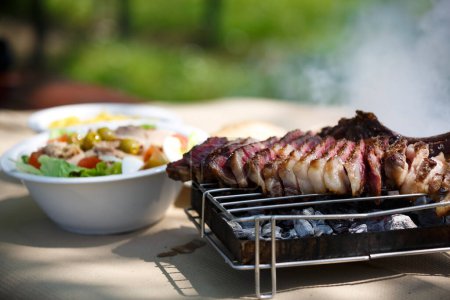 Photo for "Steak on grill Outdoors" - Royalty Free Image