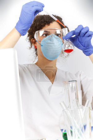 Photo for Portrait of young woman in laboratory equipment on white - Royalty Free Image