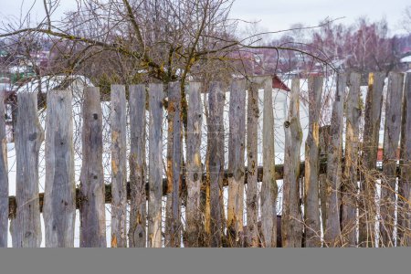 Photo for Fence around the garden of nailing boards - Royalty Free Image