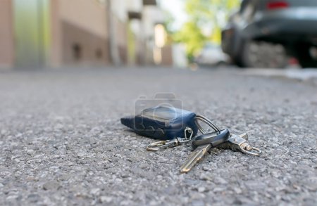 Photo for The lost keychain, car alarm remote, lies on the asphalted sidewalk - Royalty Free Image