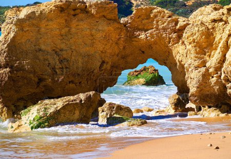 Photo for Red cliffs in blue ocean at coast of Albufeira in Portugal - Royalty Free Image