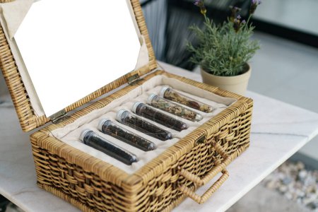 Photo for Six tube of different leaf teas collection in  wicker basket - Royalty Free Image