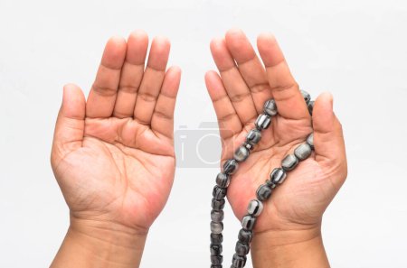 Photo for Person holding rosary on white background - Royalty Free Image