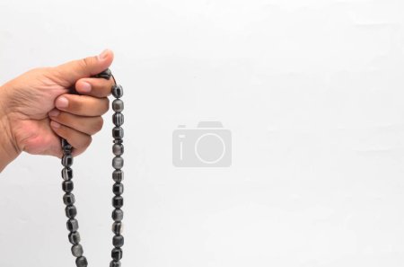 Photo for Person holding rosary on white background - Royalty Free Image