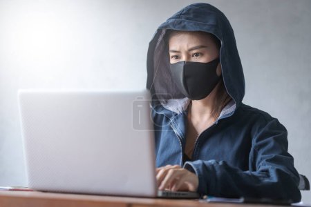 Photo for Professional hacker young women Wearing a blue robe with a hood - Royalty Free Image