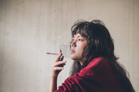 Photo for Stressed woman. A depressed woman smoking of stress - Royalty Free Image
