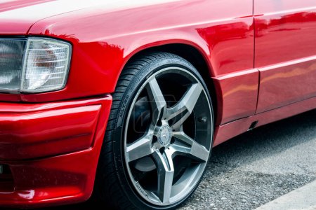 Photo for 24 May 2019, The front side of a red car with modern sport wheel, parked in the parking lot at viewpoint in Inthanon peak moutain, Chiang Mai, Thailand. - Royalty Free Image