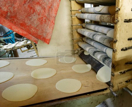 Photo for Old machine for the automatic production of Arab flatbread in the largest bread bakery of Akaba, Jordan - Royalty Free Image