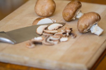 Foto de Cremini champiñones, con cuchillo, en una tabla de cortar de madera - Imagen libre de derechos