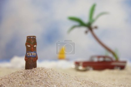 Photo for Tropical beach with tiki figure on sand - Royalty Free Image
