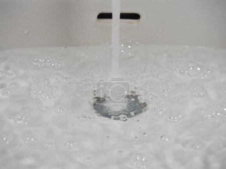 Photo for Tap faucet in basin with water - Royalty Free Image