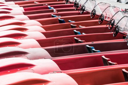 Photo for Abstract photo of red pedal boats moored at the jetty on a lake - Royalty Free Image