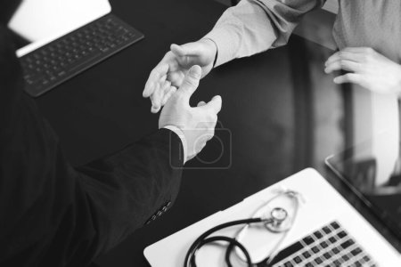 Photo for Adult business partners shaking hands" - Royalty Free Image