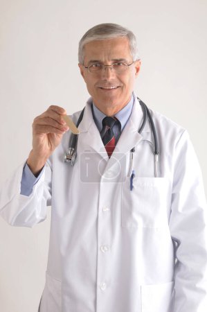 Photo for Doctor in Labcoat with Tongue Depressor. Healthcare and medicine concept - Royalty Free Image