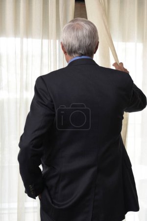 Photo for Man Peeking out Window - Royalty Free Image