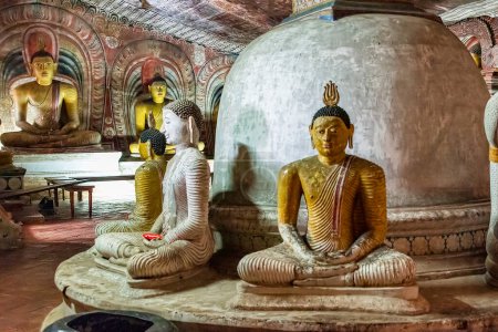 Photo for "Statues of Buddha lined up inside the cave temples at Dambulla" - Royalty Free Image