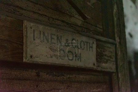 Photo for Decaying sign - Linen and cloth room' in an abandoned hospital - Royalty Free Image