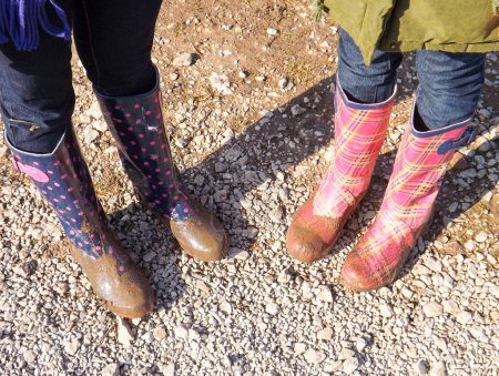 Photo for Two women wearing a rubber boot - Royalty Free Image