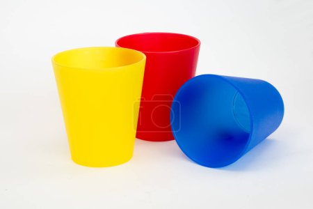 Téléchargez les photos : Tasses en plastique coloré sur fond blanc - en image libre de droit