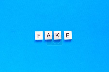 Photo pour "Fake word alphabet letters on blue background. top view. flat layout." - image libre de droit
