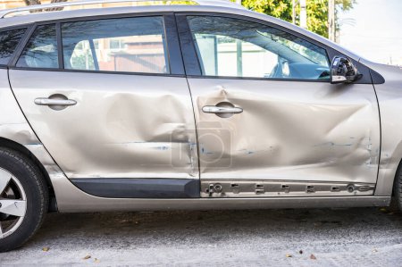 Photo for "Car door with damage on accident with dents on side " - Royalty Free Image