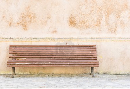 Photo for "Wooden bench in front of house wall" - Royalty Free Image