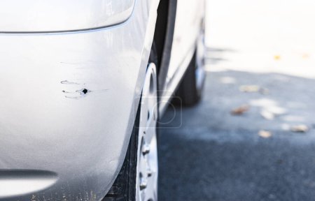 Photo for "Car damage of scratched silver bumper" - Royalty Free Image