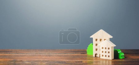 Photo for Figures of residential buildings on a gray background. Buy purchase and sale, housing rental. Community owners of apartments. Construction industry real estate, maintenance utilities. Mortgage loan - Royalty Free Image